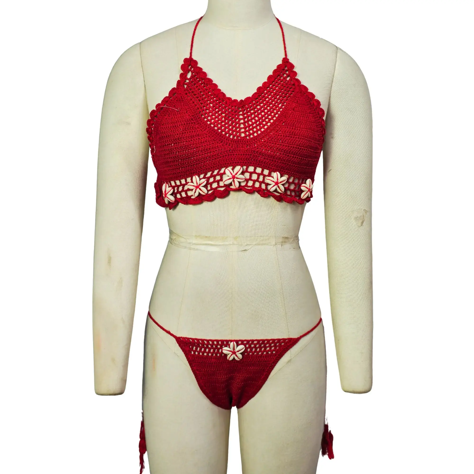 Red crochet bikini set for women with flower embellishments and halter-neck closure.